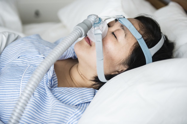 A woman wearing anti-snoring chin straps Premium Photo